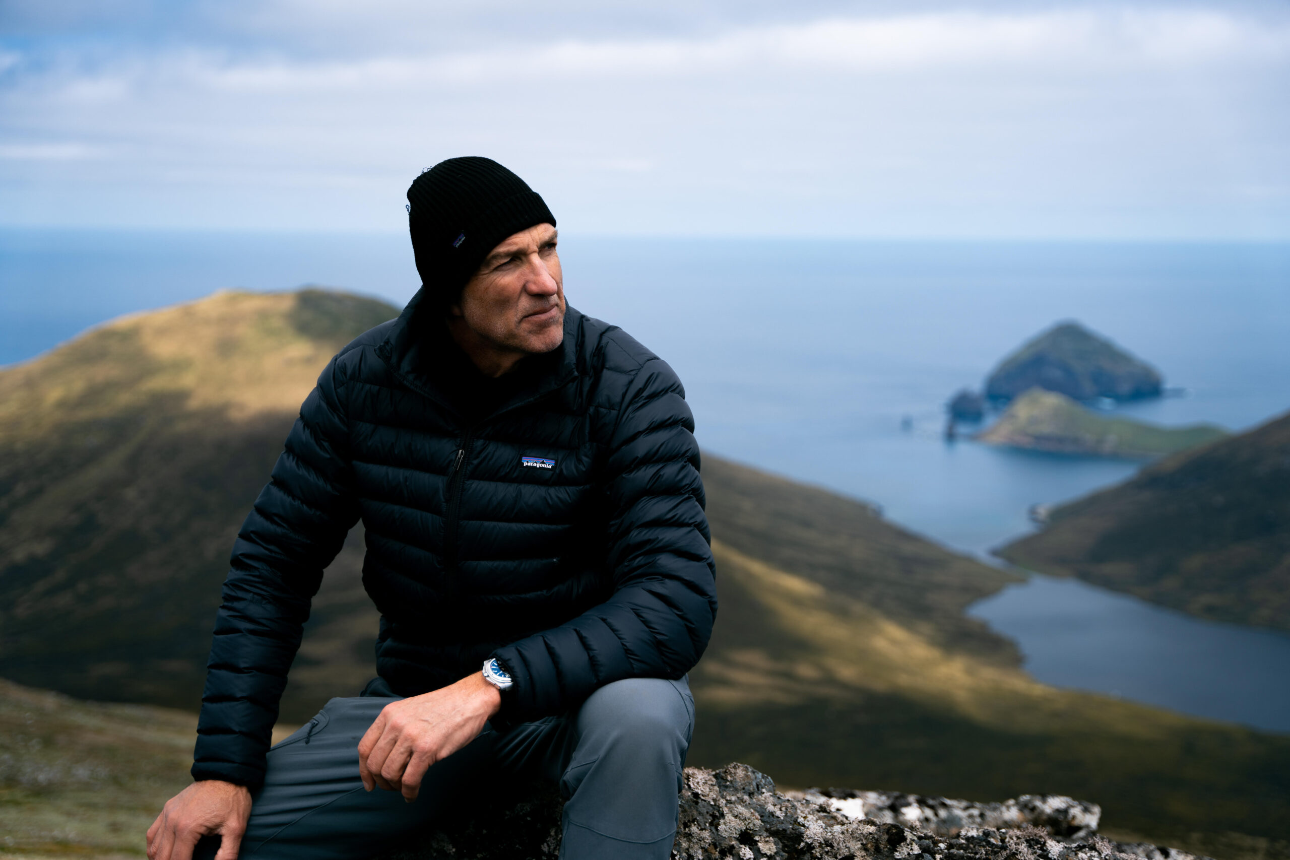 Tim Jarvis sitting pensively on hill at Macquarie Island